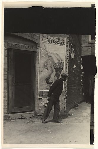 [Man in Front of Doorway of Liberty Cafe, with Walter L. Main Circus Poster on Wall]