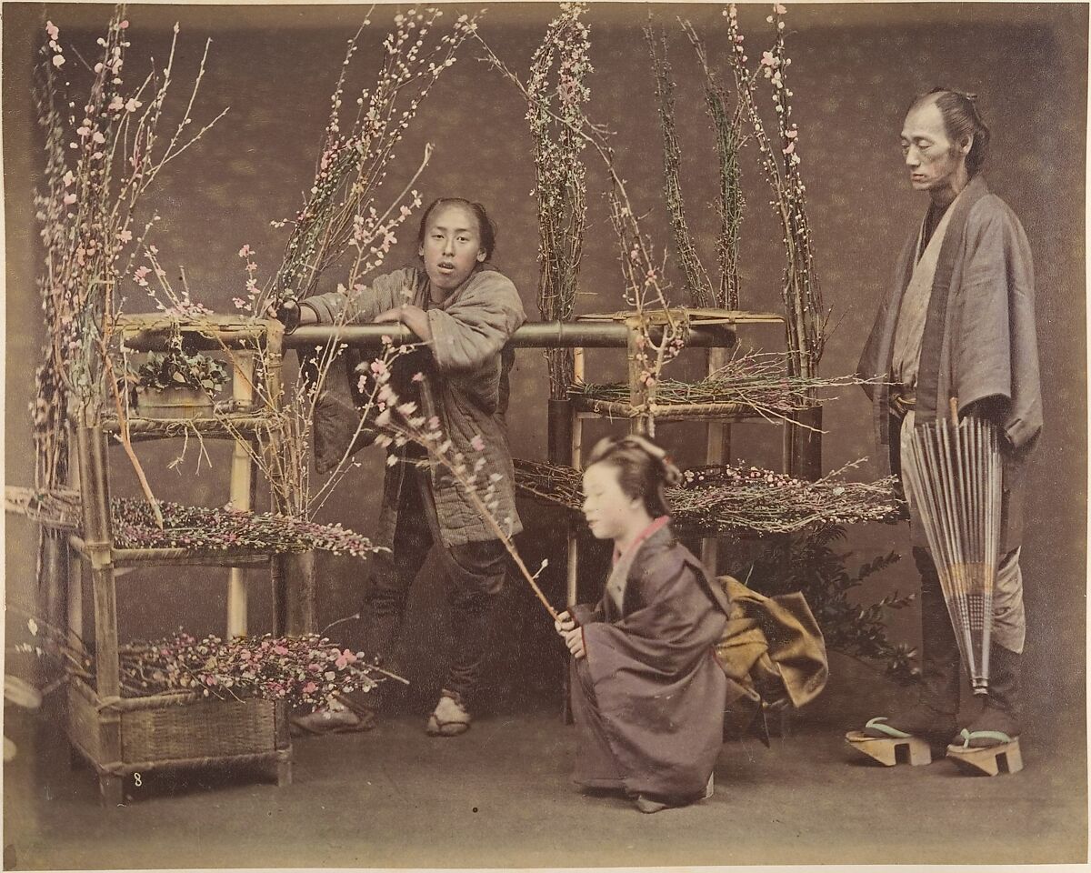 [Two Japanese Men and One Japanese Woman Posing with Flowering Branches], Unknown, Albumen silver print from glass negative with applied color 