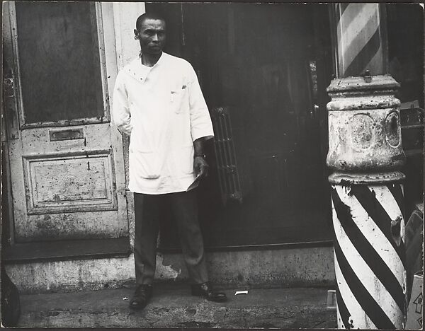[Barber in White Coat Standing on Street Beside Striped Pole at Entrance to Shop, New York], Leon Levinstein (American, Buckhannon, West Virginia 1910–1988 New York), Gelatin silver print 