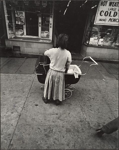 [Young Girl in White Sweater Holding Baby Stroller, New York], Leon Levinstein (American, Buckhannon, West Virginia 1910–1988 New York), Gelatin silver print 