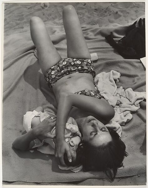 [Beach Scene: Woman in Bikini Cuddling Baby, Coney Island, New York], Leon Levinstein (American, Buckhannon, West Virginia 1910–1988 New York), Gelatin silver print 