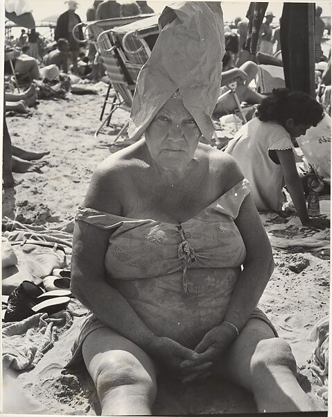 [Beach Scene: Woman Wearing Paper Bag Hat, Coney Island, New York], Leon Levinstein (American, Buckhannon, West Virginia 1910–1988 New York), Gelatin silver print 