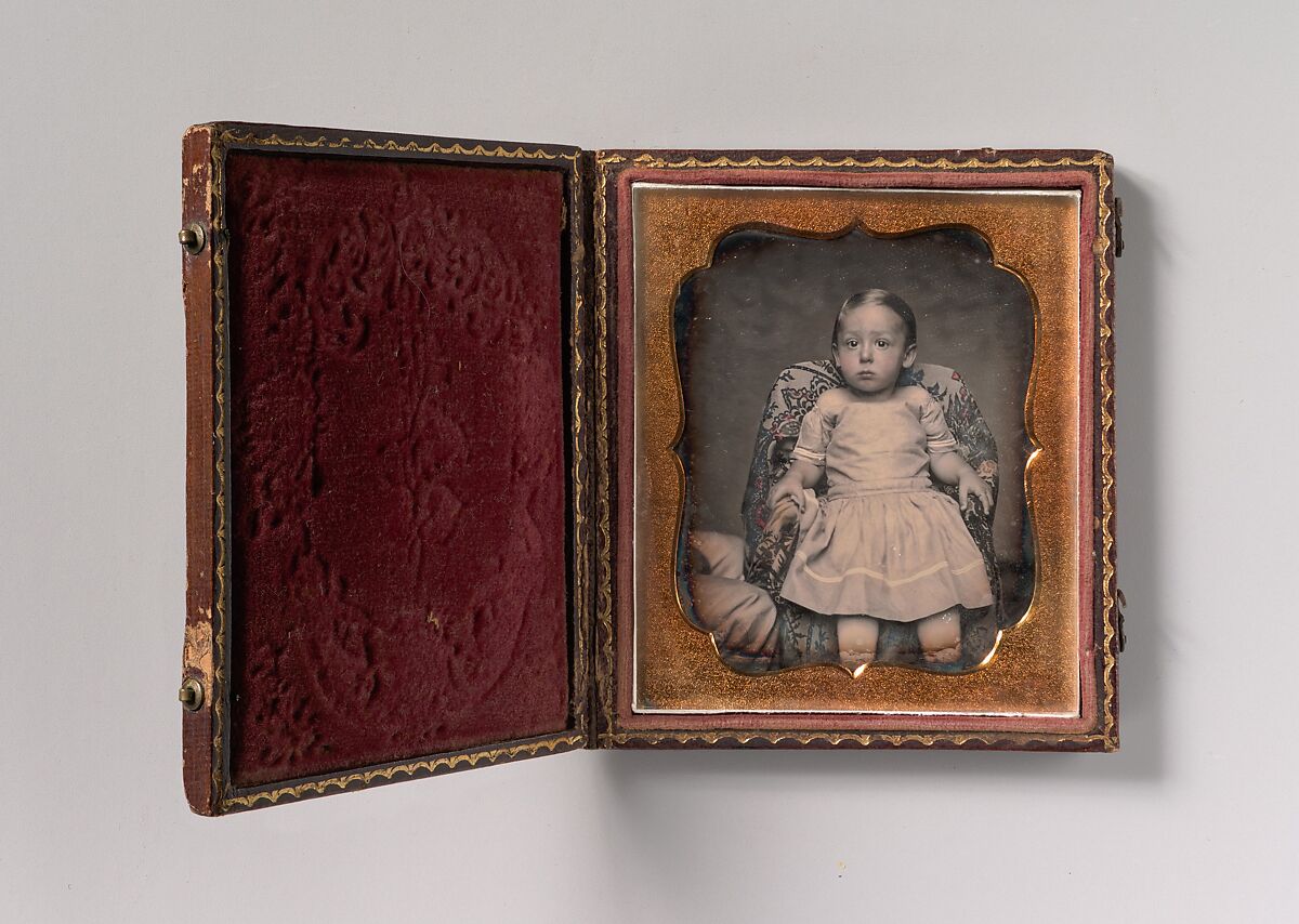 [Child Sitting on Chair Draped with Floral Print Fabric], Unknown (American), Daguerreotype with applied color 