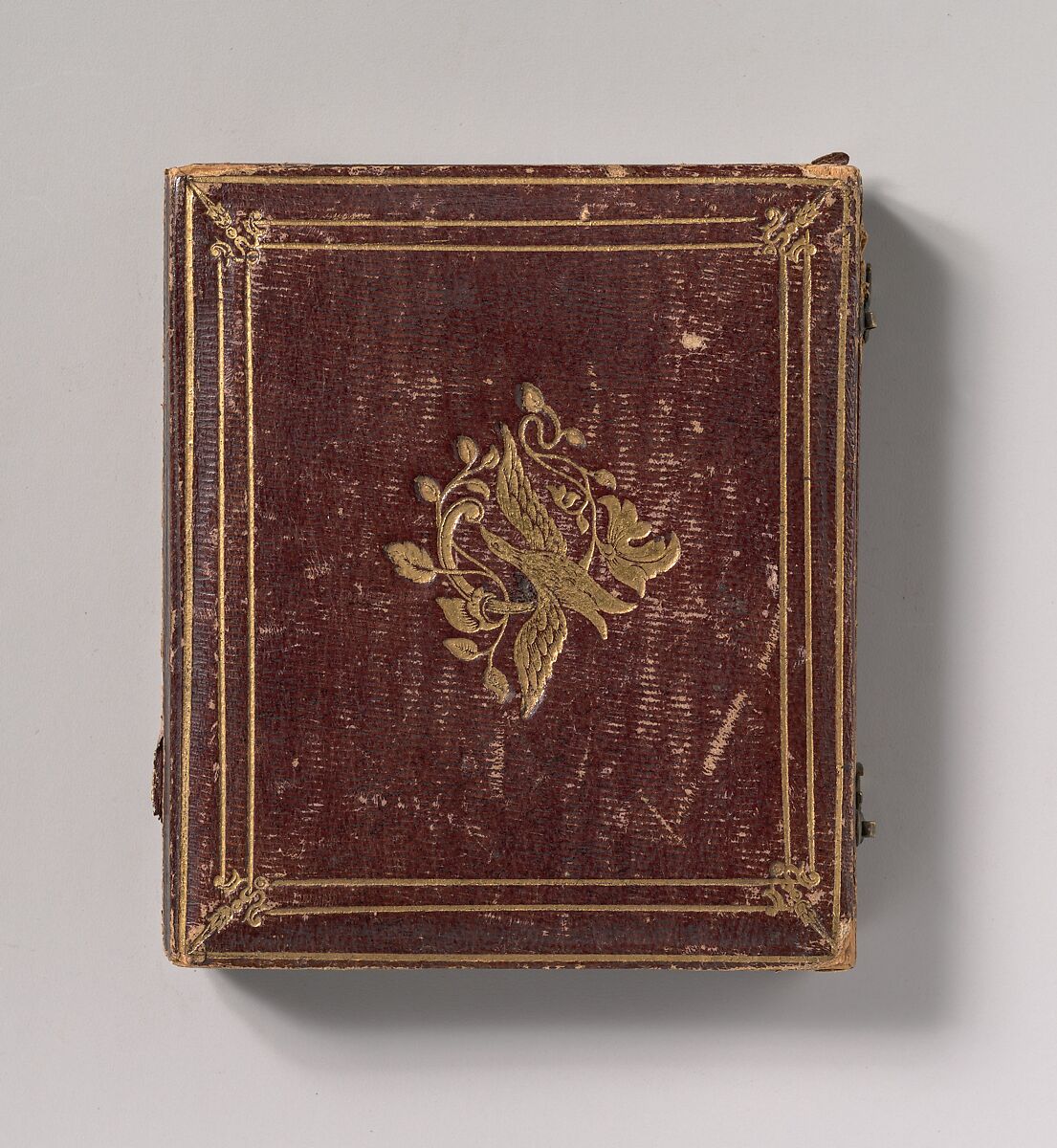 [Seated Young Man Resting Arm on Table Beside Daguerreotype Case], Unknown (American), Daguerreotype with applied color