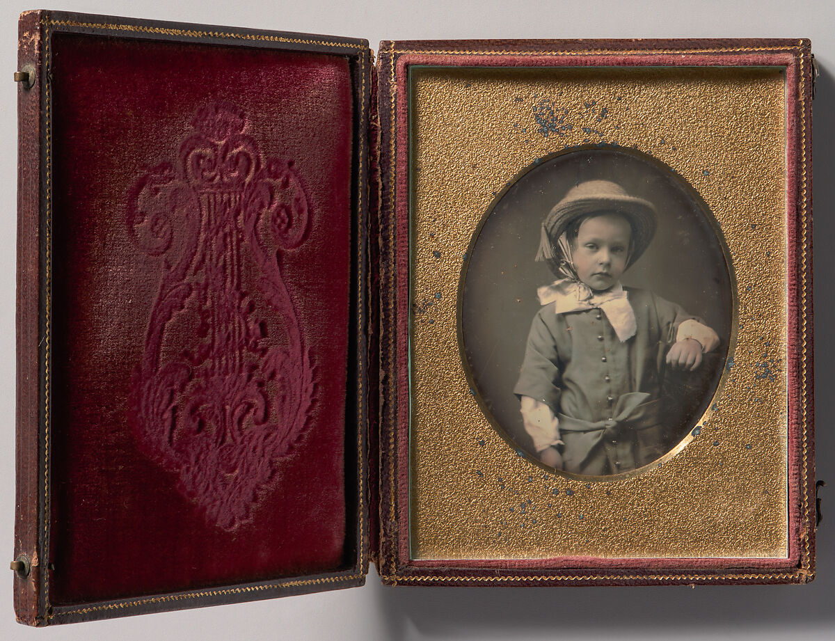 [Child Wearing Straw Hat, Arm Resting on Table], Unknown (American), Daguerreotype with applied color 