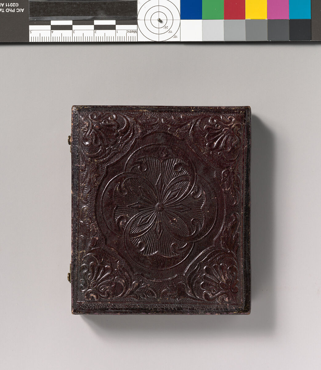 [Barefoot Boy Holding Hat and Drum Stick, Leaning Forearm on Child-sized Drum on Table], Unknown (American), Daguerreotype