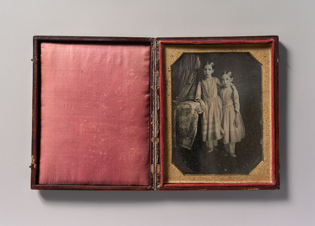 [Two Identically Dressed Young Girls Standing Next to a Table], Unknown (American), Daguerreotype 