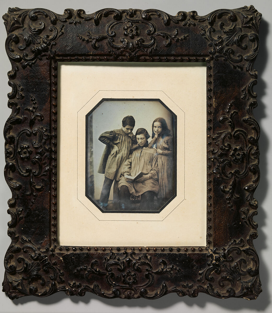 [Three Children, One Seated Holding an Open Book, the Other Two Standing, in Front of a Light Background], Unknown (French), Daguerreotype 