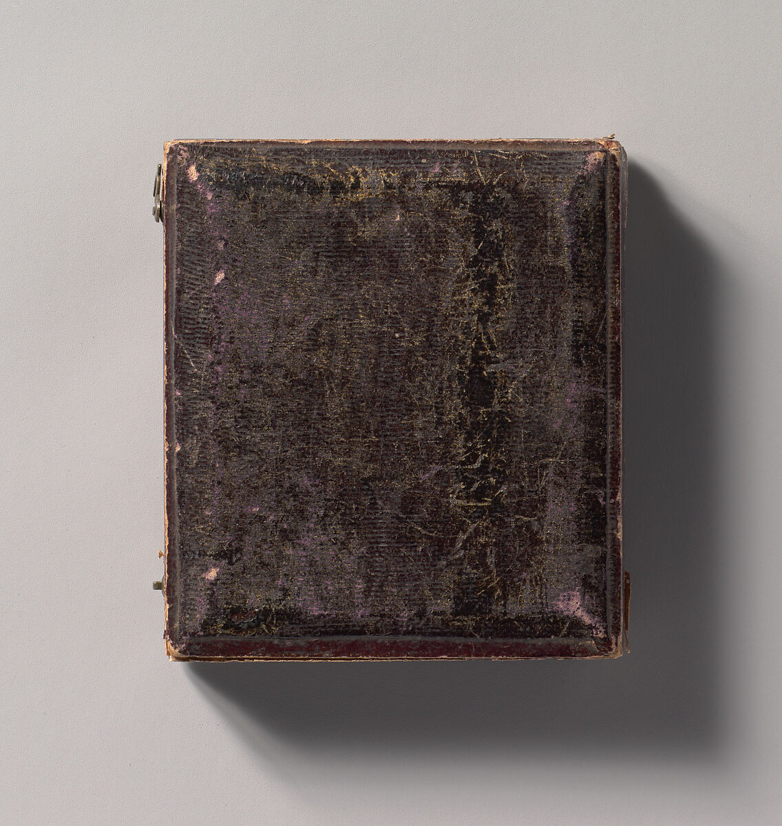 [Young Woman Seated Next to a Table with Elbow Resting on a Book], Unknown (American), Daguerreotype with applied color