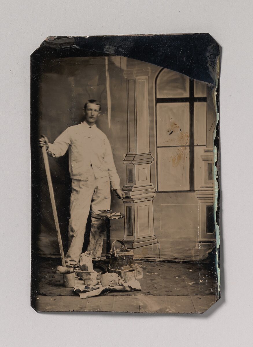 [Painter, Standing in Front of a Painted Window Backdrop, with Brushes, Bucket, and Paint Cans], Unknown (American), Tintype 