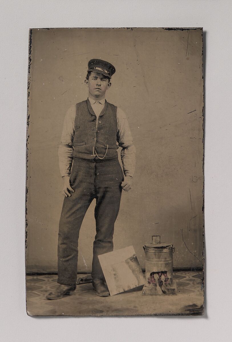 [Tinsmith with Coal Heater and Sheet of Tin], Unknown (American), Tintype with applied color 