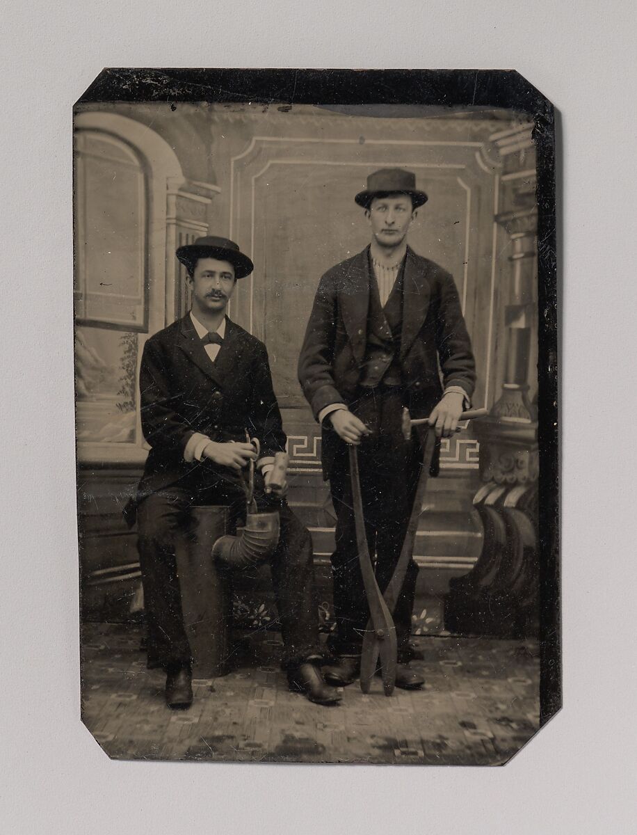 [Two Stovepipe Makers, One with a Hammer and Tin Snips, the Other Sitting on Stovepipe Assembly with Tin Snips and Mallet], Unknown (American), Tintype 