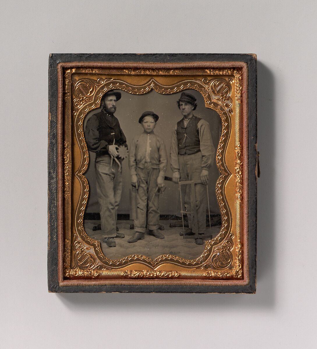 [Two Men and a Boy with Outside Calipers, Backsaw, Square, and Frame Saw], Unknown (American), Tintype with applied color 