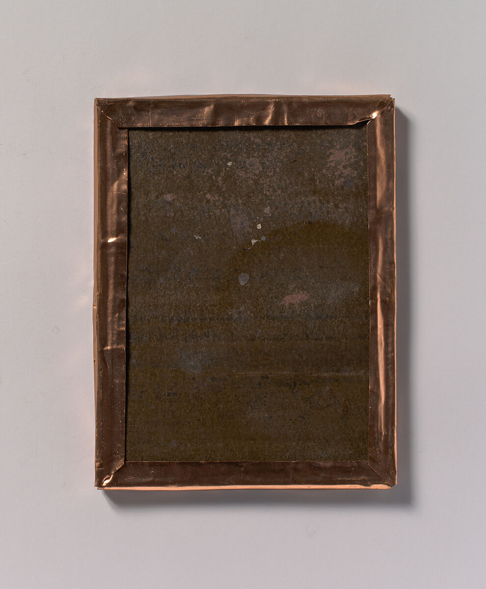 [Workman Holding Brush and Rectangular Tray, Arm Resting on Fake Rock], Unknown, Tintype with applied color