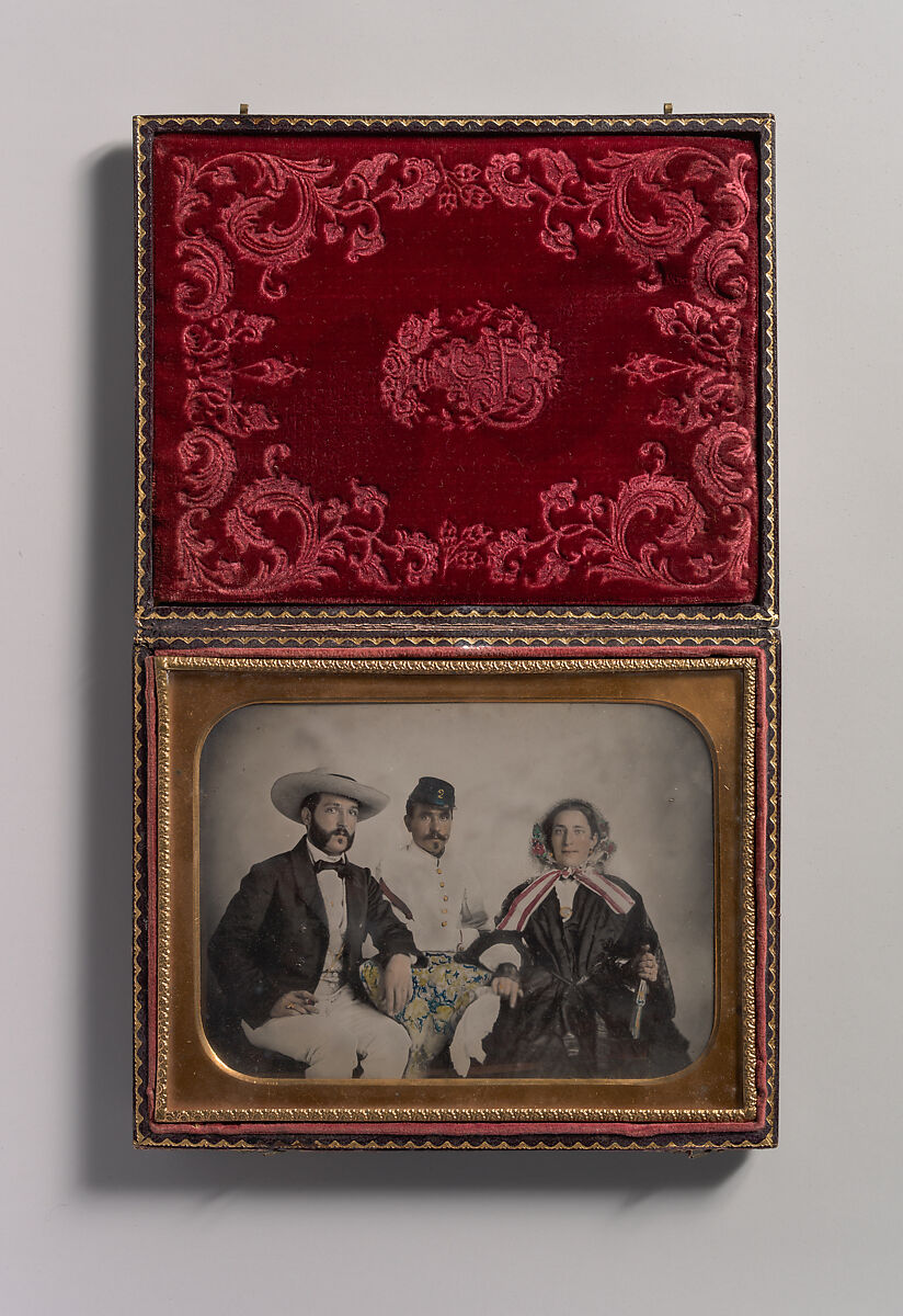 [Two Men, One in Military Garb, and a Woman, Seated Around a Table], Unknown (American), Ambrotype with applied color 