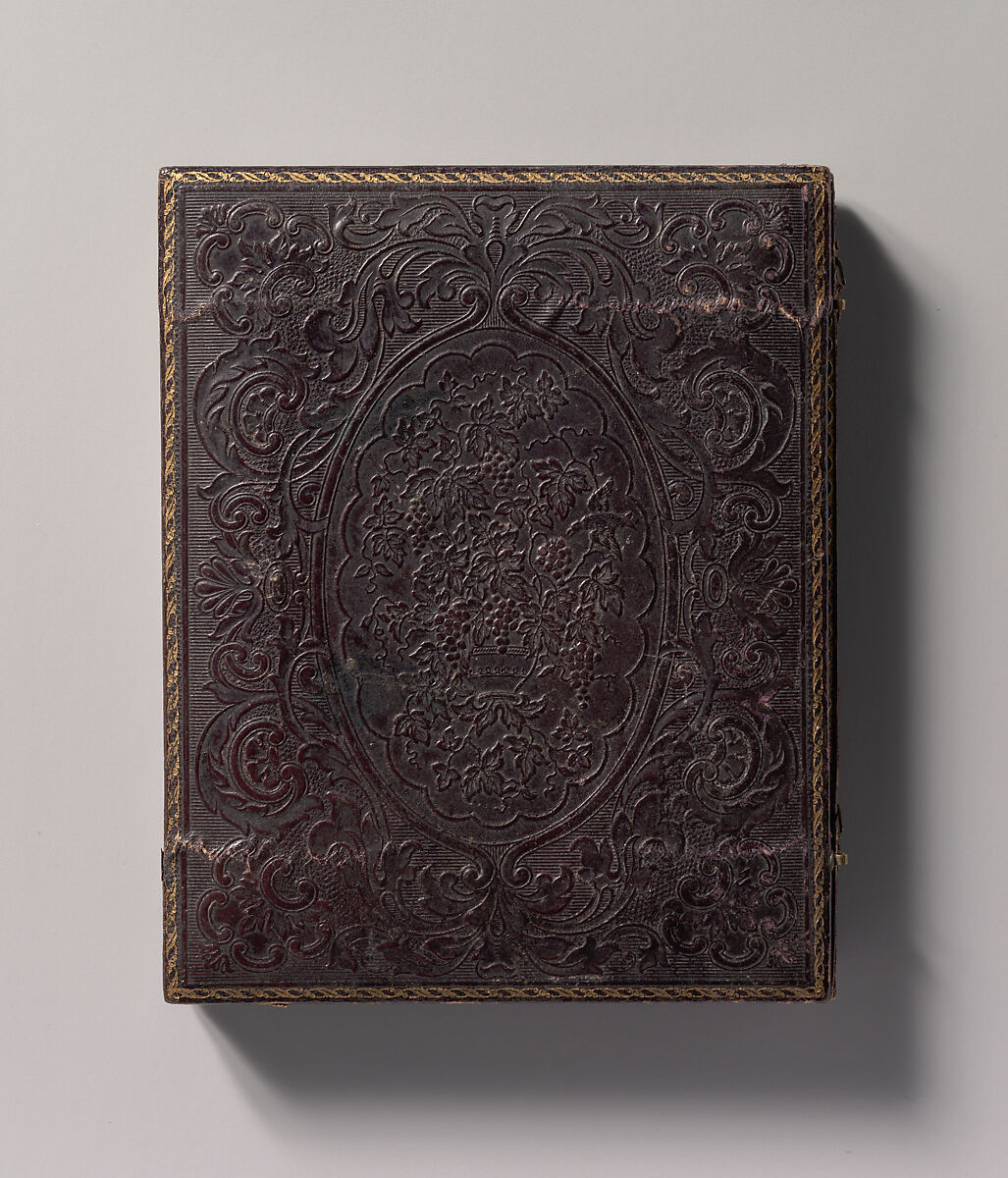 [Two Men, One in Military Garb, and a Woman, Seated Around a Table], Unknown (American), Ambrotype with applied color