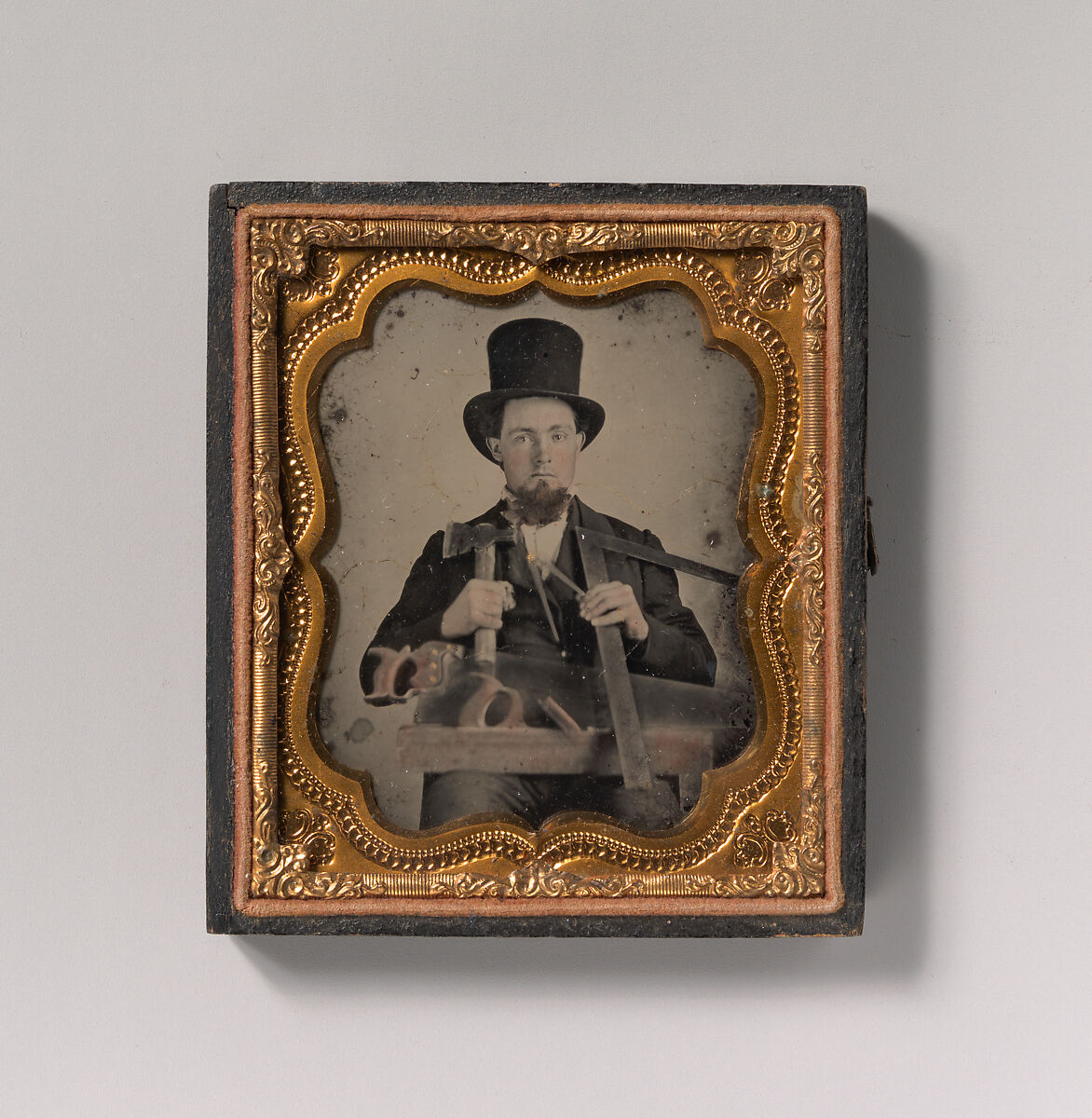 [Carpenter in Top Hat with Hatchet, Compass, Square, and Hand Saw], Unknown (American), Ambrotype with applied color 