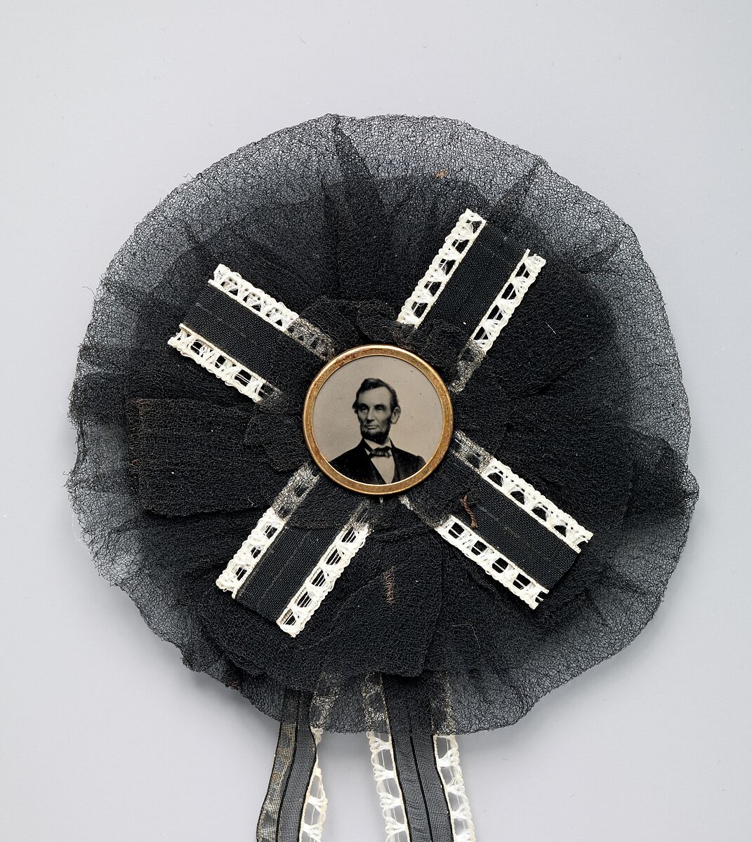 [Mourning Corsage with Portrait of Abraham Lincoln], Unknown (American), Black and white silk with tintype set inside brass button