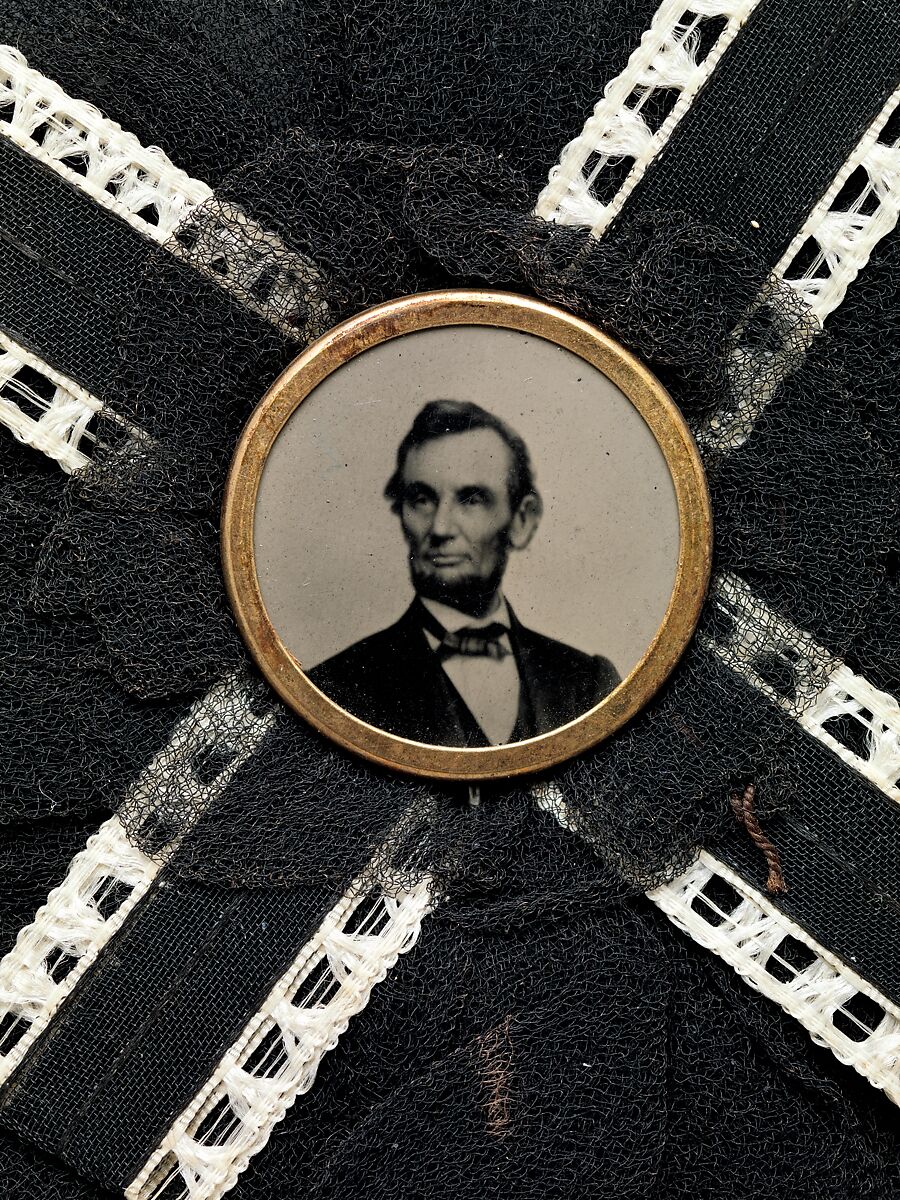 [Mourning Corsage with Portrait of Abraham Lincoln], Unknown (American), Black and white silk with tintype set inside brass button