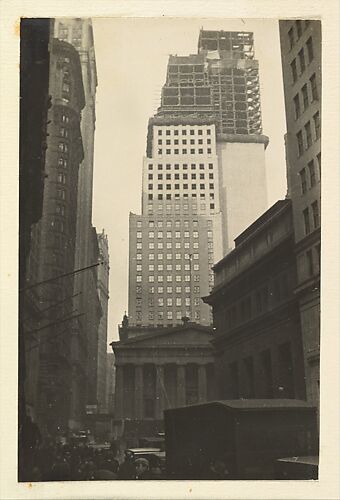[View of Wall and Broad Streets, with the J. P. Morgan & Company Building,  the U.S. Customs House, and New Building Construction, New York City]