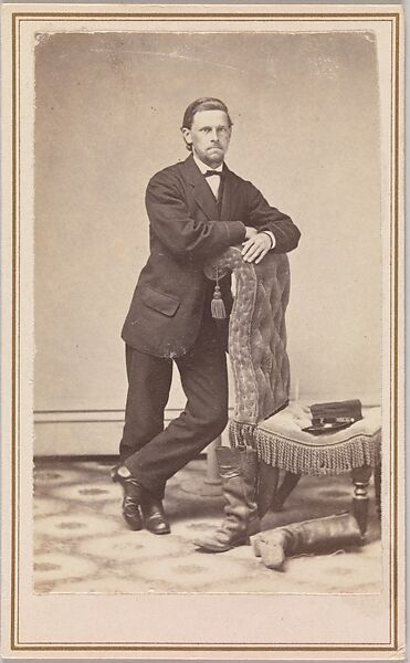 [Young Man, Standing, beside Empty Chair with Civil War Kepi on Seat, and Worn Boots, in Studio], C. Burgess (American), Albumen silver print from glass negative 
