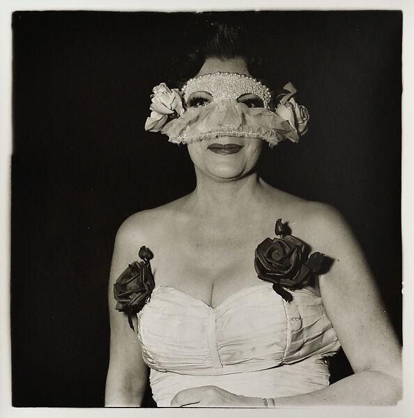 Diane Arbus - Lady at a masked ball with two roses on her dress