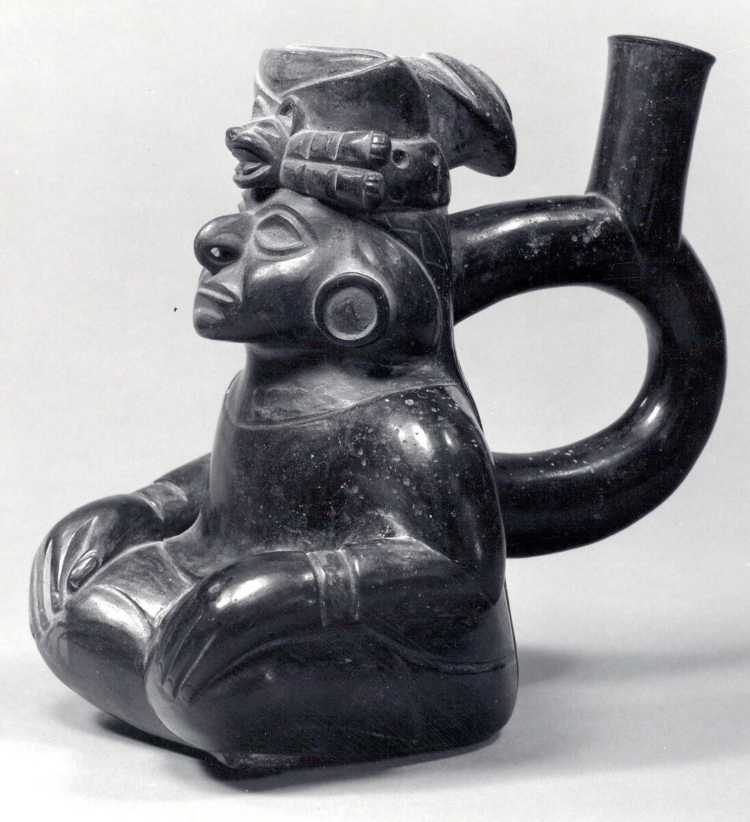 Stirrup-spout bottle with seated figure, Moche artist(s), Ceramic, Moche