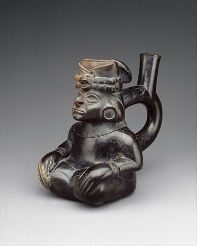 Stirrup-spout bottle with seated figure