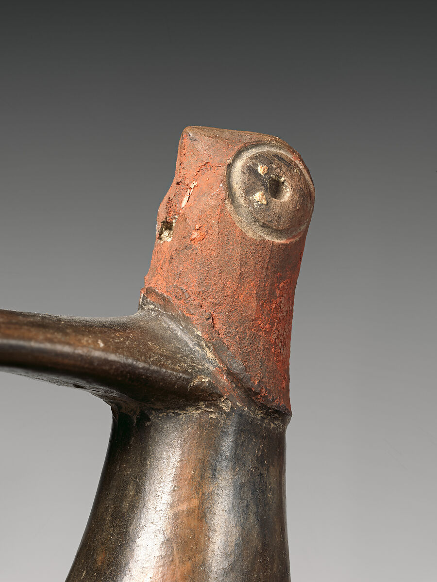 Spout-and-bridge bottle with feline face, Paracas artist(s), Ceramic, post-fire paint, Paracas