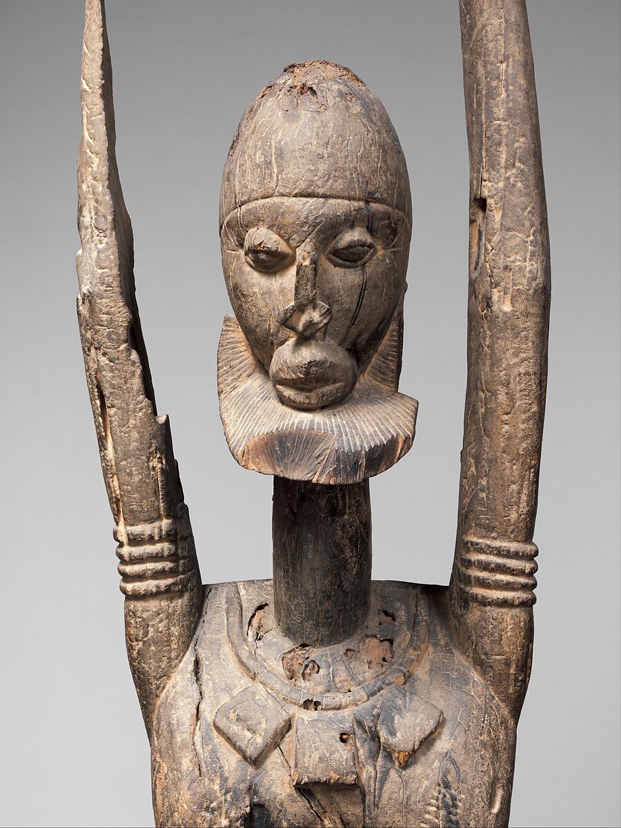 Priest with raised arms, Dogon blacksmith, Wood, applied organic materials, Dogon peoples
