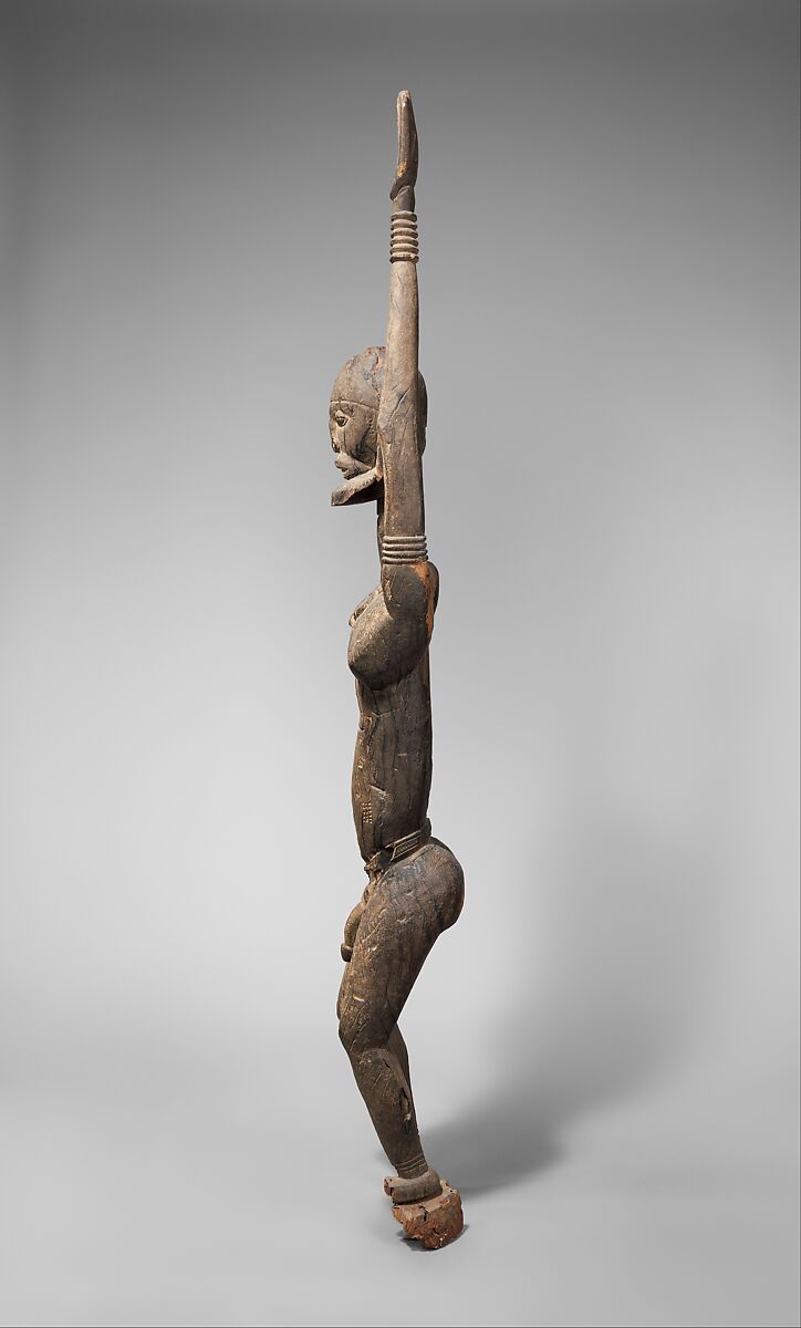 Priest with raised arms, Dogon blacksmith, Wood, applied organic materials, Dogon peoples