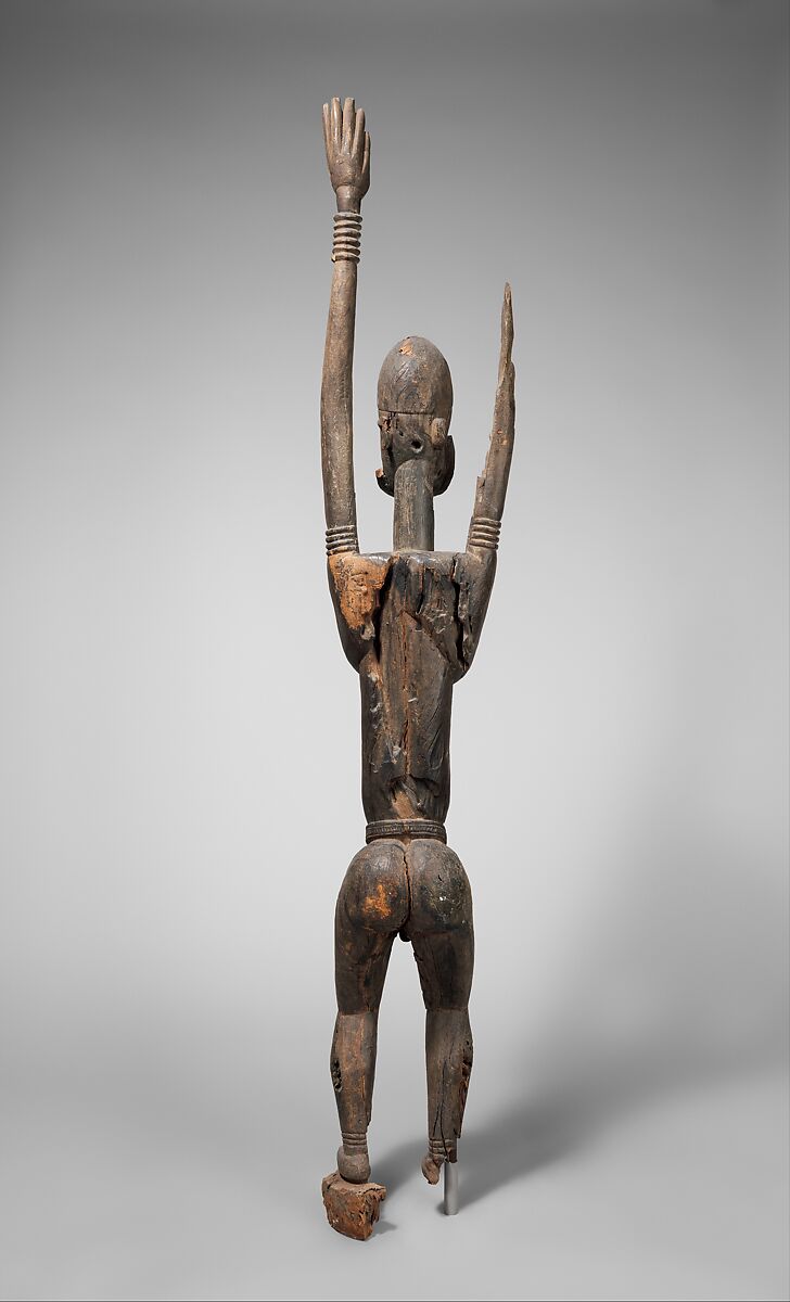 Priest with raised arms, Dogon blacksmith, Wood, applied organic materials, Dogon peoples