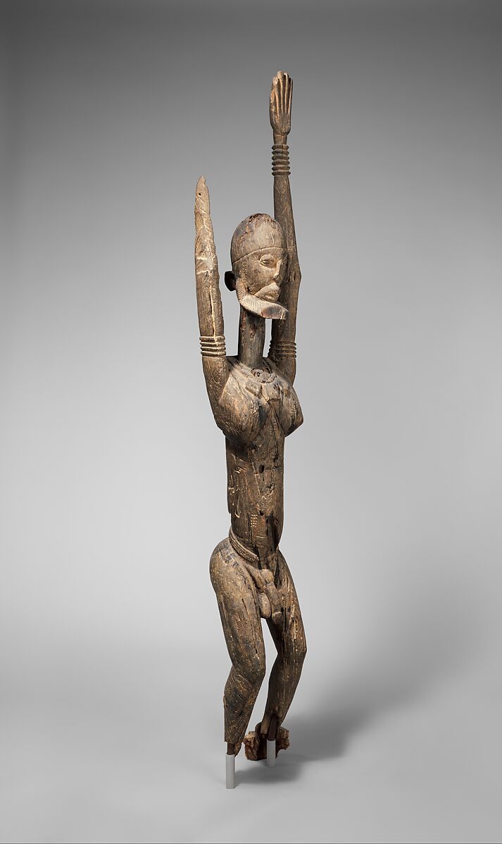 Priest with raised arms, Dogon blacksmith, Wood, applied organic materials, Dogon peoples