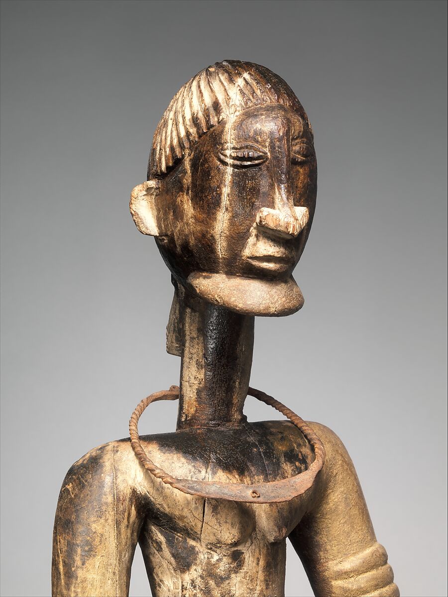 Seated binukedine ( priest), Dogon blacksmith, Wood, iron, Dogon peoples