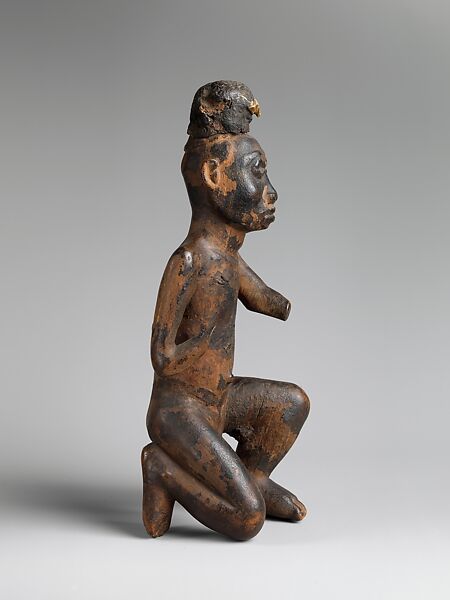 Kneeling nkisi (power figure), Kongo artist, Wood, cloth traces, applied organic matter, bone, resin, Kongo peoples