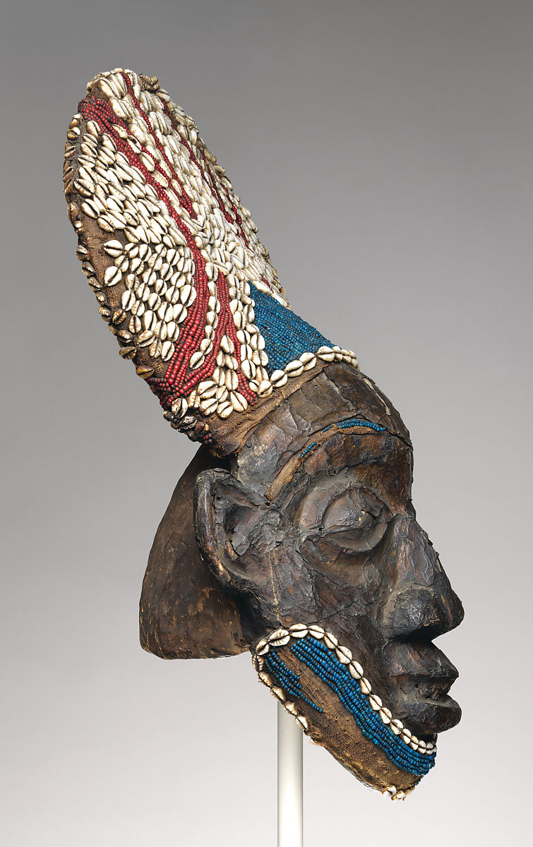 Helmet crest from a nja masquerade, Grassfields artists, Wood, copper, glass beads, raffia palm, cowrie shells, Bamum kingdom