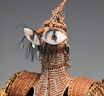 Body mask, Asmat artist, Mulberry fiber, rattan, sago palm leaves, wood, bamboo, cassowary bone, cassowary feathers, feathers, coix seeds, pigment, Asmat people