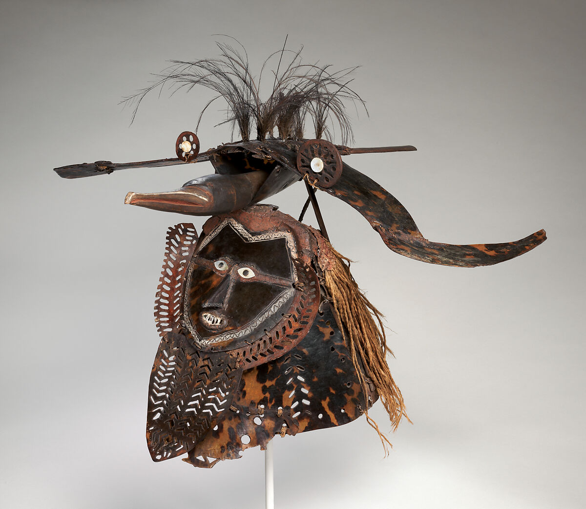 Krar (mask), Mabuiag Island artist, Turtle shell, wood, cassowary feathers, fiber, resin, shell, paint, Torres Strait Islander