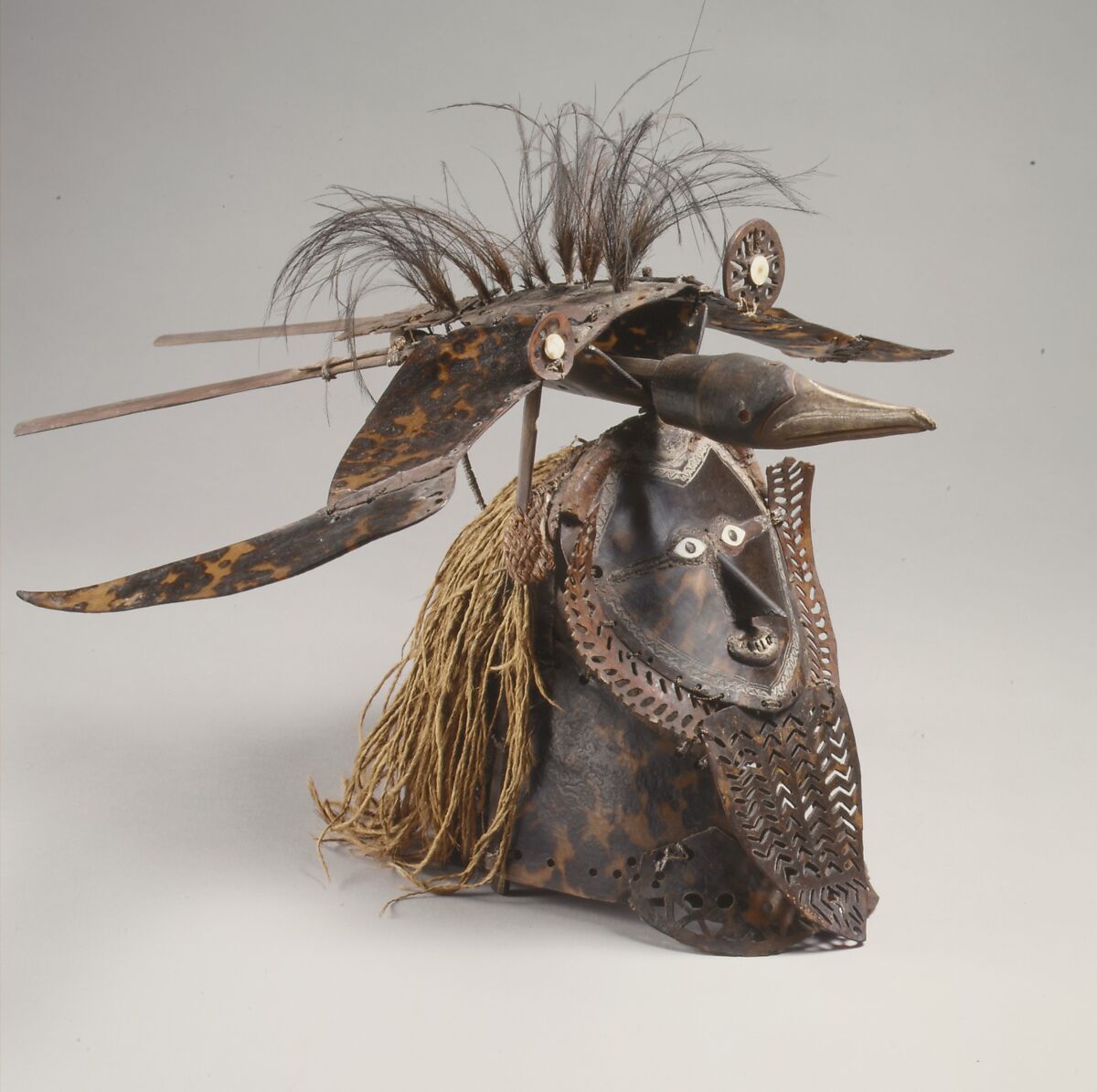 Krar (mask), Mabuiag Island artist, Turtle shell, wood, cassowary feathers, fiber, resin, shell, paint, Torres Strait Islander