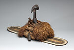 Reliquary, Kota artist, Wood, cane, pigment, raffia palm, leaves, copper alloy, resin, primate skull, spire shell, Kota peoples