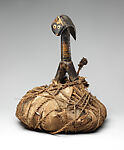 Reliquary, Kota artist, Wood, cane, pigment, raffia palm, leaves, copper alloy, resin, primate skull, spire shell, Kota peoples