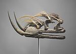 Kòmòkun or kònòkun (head of Kòmò or Kònò) helmet mask, Bamana or Senufo blacksmith, Wood, bird skull, porcupine quills, horns, cotton cords, iron, plant fiber, applied organic materials, Bamana or Senufo peoples