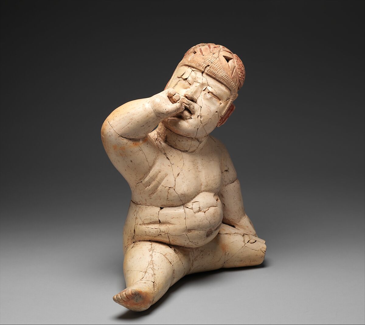 Seated hollow figure with helmet, Las Bocas artist(s), Ceramic, cinnabar, red ochre, Olmec