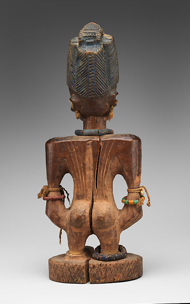 Twin Figure: Male (Ibeji), Oyo-Yoruba artist, Wood, camwood powder, brass, glass beads, cowries, blueing, string, Oyo-Yoruba peoples