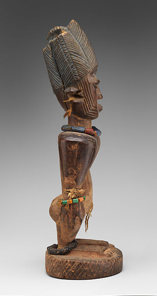 Twin Figure: Male (Ibeji), Oyo-Yoruba artist, Wood, camwood powder, brass, glass beads, cowries, blueing, string, Oyo-Yoruba peoples