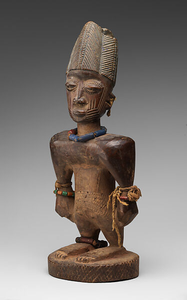 Twin Figure: Male (Ibeji), Oyo-Yoruba artist, Wood, camwood powder, brass, glass beads, cowries, blueing, string, Oyo-Yoruba peoples