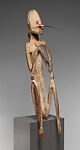 Male ancestor figure, Asmat artist, Wood, paint, sago palm leaves, fibers, mulberry fiber, pig tusk, cassowary quills, hair, coix seed, Asmat people