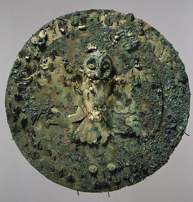 Shield with owl figure, Moche artist(s), Gilded copper, silvered copper, shell, beads, fibers, Moche 