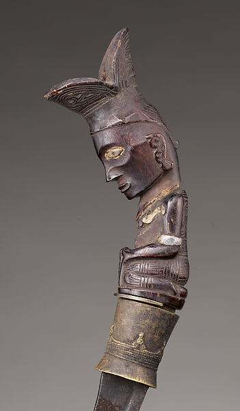 Piso sanalenggam (sword), Toba Batak artist, Water buffalo horn, copper/zinc alloy (sun inlay and end of the handle), lead (necklace and eyes of the handle figure), iron alloy, Toba Batak