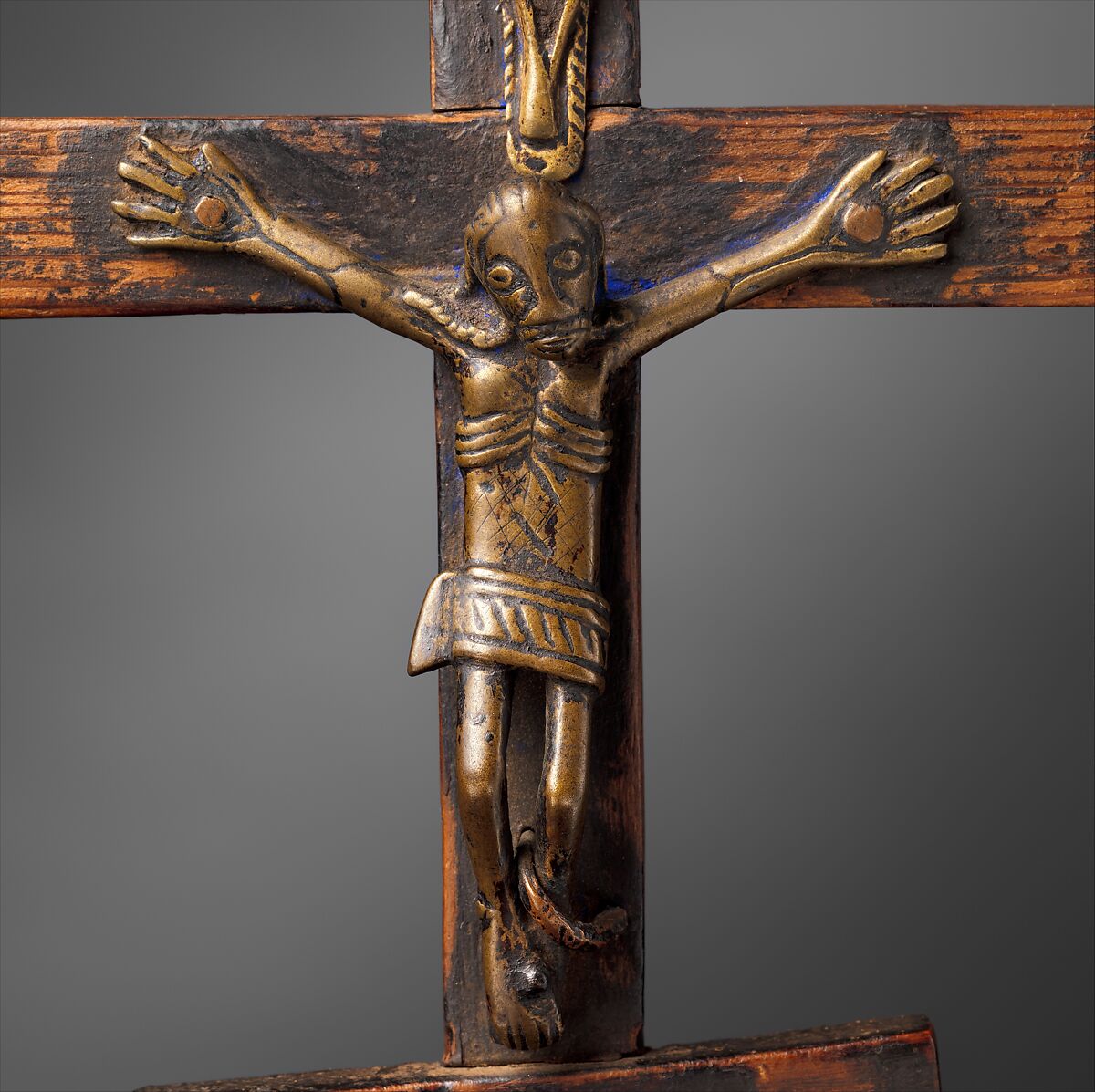 Triple Crucifix, Kongo artist, Open-back cast brass (central figure), solid cast brass (top and bottom figures), forged iron nails, brass, copper, wood, ultramarine pigment, Kongo